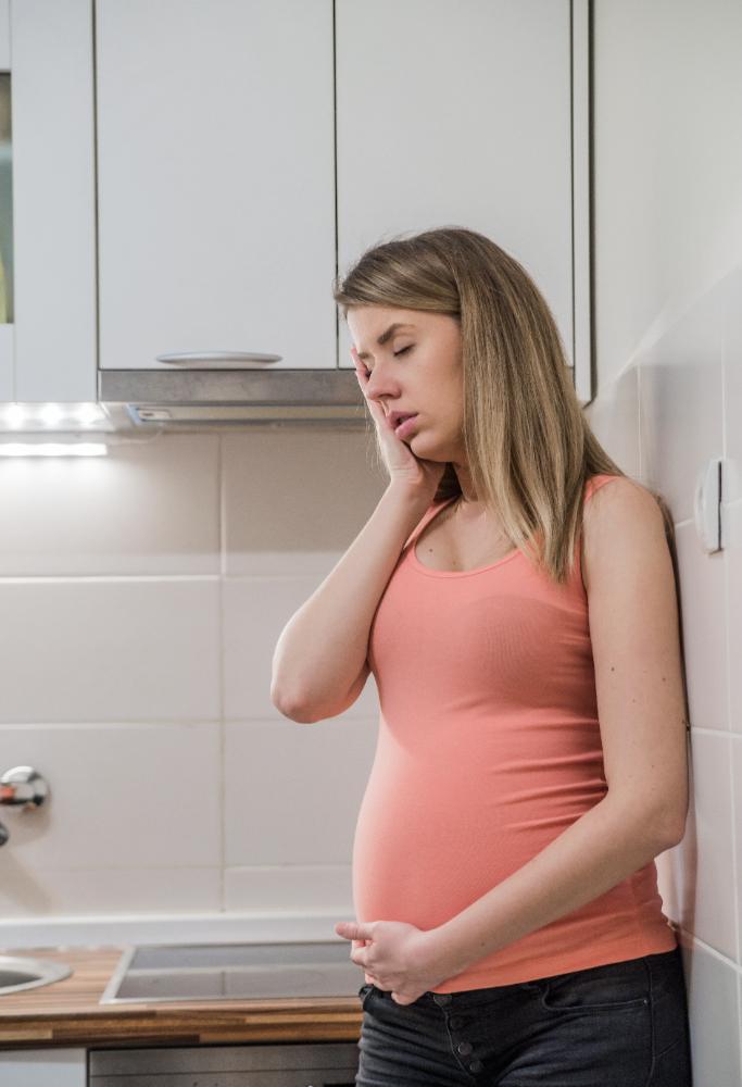 Why do women suffer from heartburn during pregnancy?